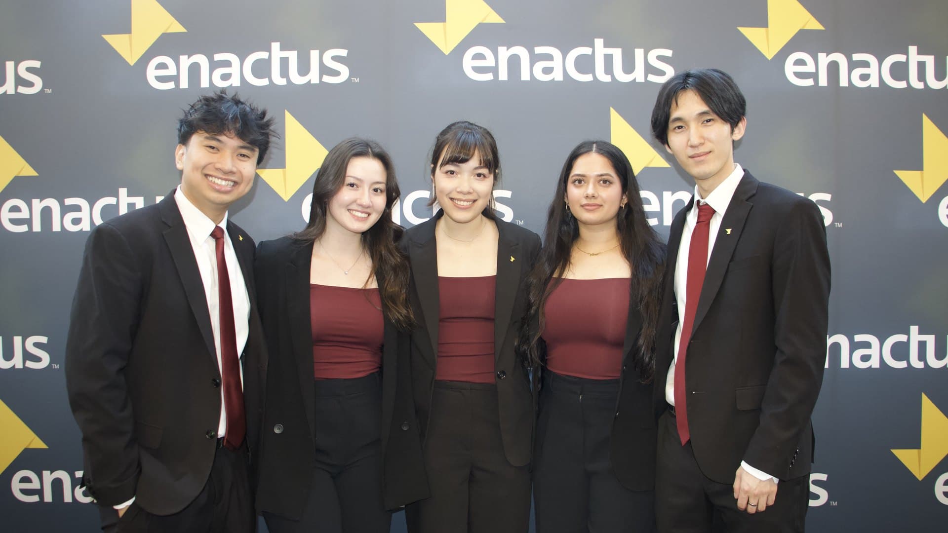 The 2026 Nationals presenting team in front of the Enactus backdrop